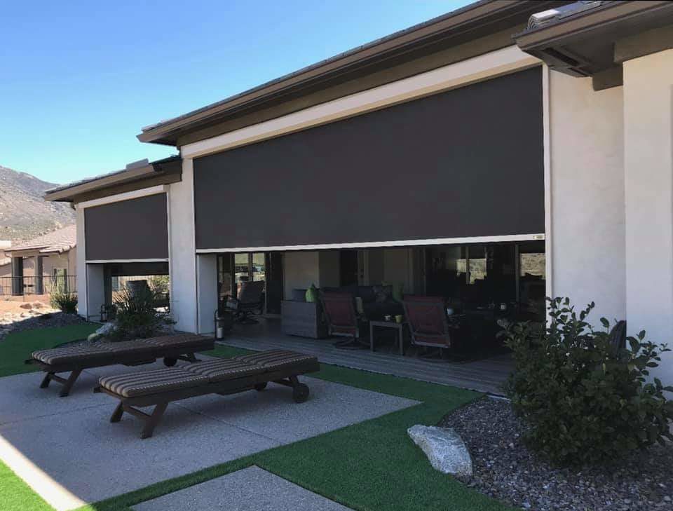 Dark exterior solar shades installed on a home patio