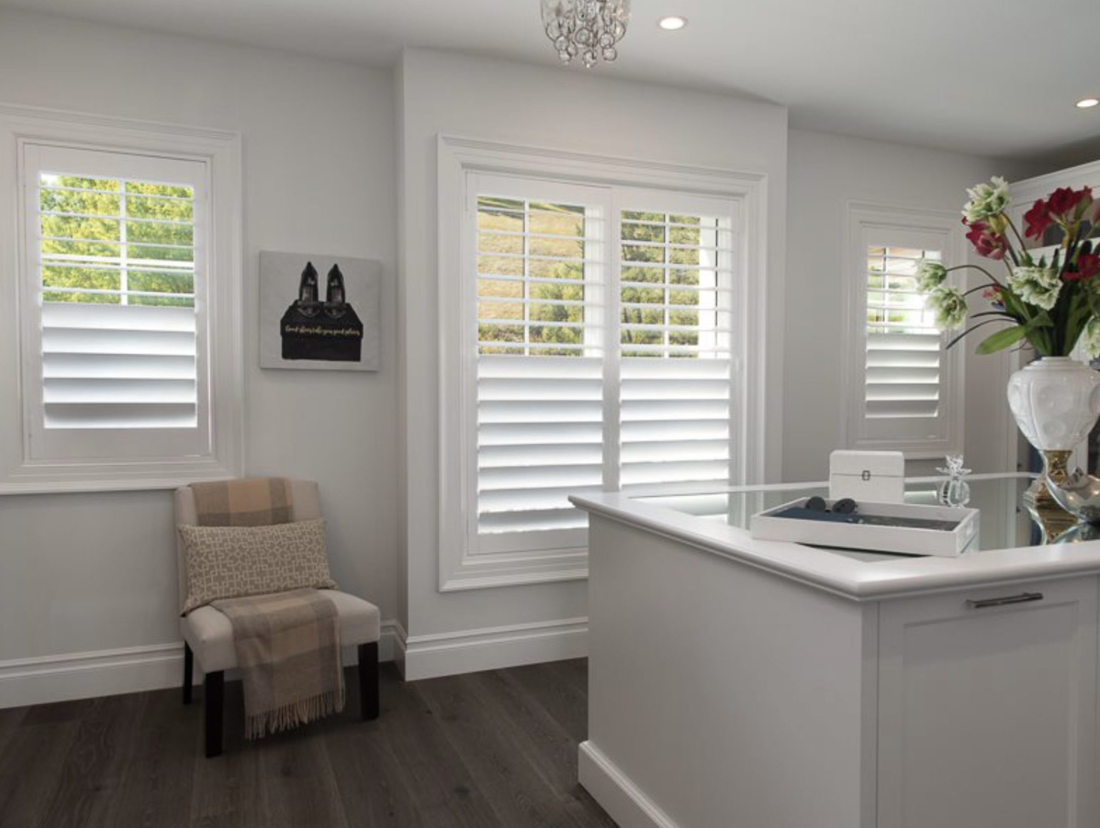 White plantation shutters across three windows